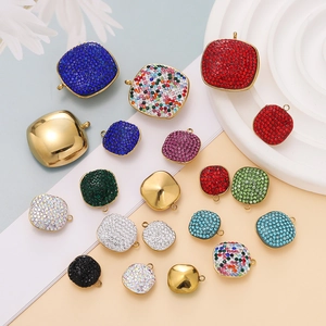 Close-up of colorful square crystal charms and gold pendants for DIY necklace making