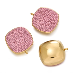 Detailed close-up of square gold-plated pendants with pink rhinestones and smooth back