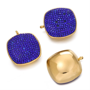 Macro detail of square stainless steel charms with vibrant blue pavé rhinestones