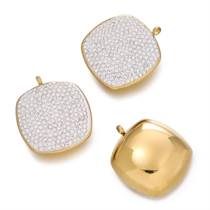 Detailed macro view of square gold pendants with micro-pave white rhinestones set in steel