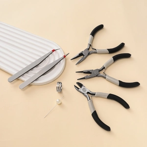 Detail view of professional jewelry making tool set with pliers, tweezers and jump ring tool