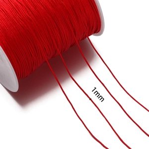 Detail showing red 1mm nylon braided cord on spool for DIY jewelry and knots