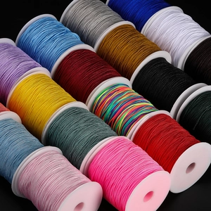 Detailed view of colorful 1mm nylon cords for DIY jewelry weaving on black background