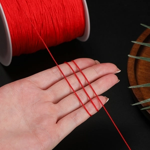 Detailed close-up of shiny red nylon braided cord for DIY jewelry and Chinese knots