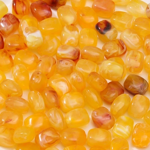 Detailed macro view of amber acrylic beads with marble texture for jewelry DIY
