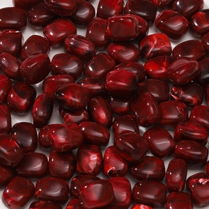 Macro view of dark red marble texture acrylic barrel beads for DIY jewelry making