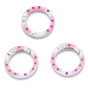 Drie gekleurde ronde veer-O-ringen met roze golven en paarse stippen voor DIY-projecten