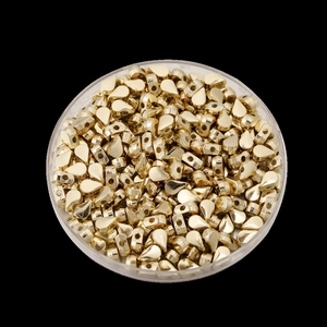 Macro-opname van gouden druppelvormige CCB kralen in een ronde doos voor DIY sieraden