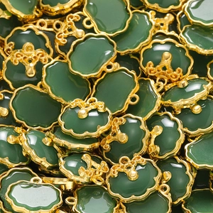 Macro shot of bulk retro Chinese style green jade pendants with gold metal cloud lock frames