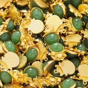 Macro detail of oval green faux jade gems in gold alloy settings for jewelry making