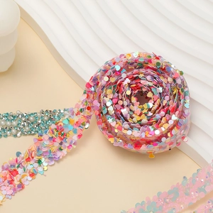 Macro detail of self-adhesive rhinestone tape with colorful heart sequins for DIY crafts