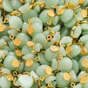 Close-up of bulk money bag pendants with small gold coins for DIY jewelry making