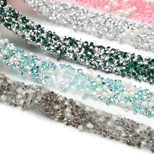 Macro shot of colorful rhinestone and pearl trim strips for DIY fashion crafts