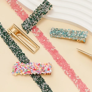 Detailed view of assorted rhinestone hair clips featuring pearls and glitter textures