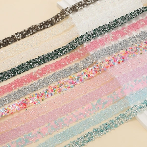 Detailed view of colorful rhinestone strips with pearls and sequins for DIY accessory decor