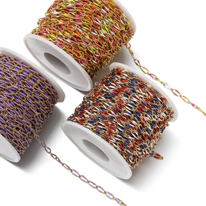 Detail of colorful enamel twisted oval metal chains on white spools for DIY jewelry making