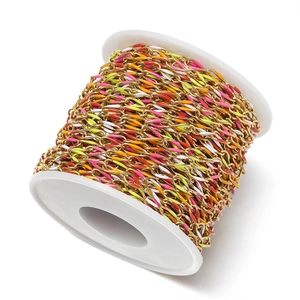 Close-up of colorful enamel twisted oval chain on a white spool for DIY jewelry making