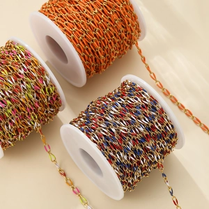 Macro view of colorful enamel twisted oval chains on white spools for DIY jewelry making