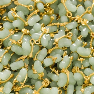 Detailed pile of butterfly charms with green faux-jade wings and golden metal frames