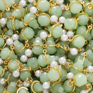 Detailed view of handmade light green gourd pendants with white pearl and gold plating