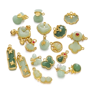 Macro detail of various Chinese style faux jade pendants with gold alloy frames