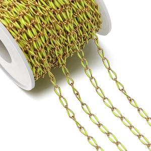 Close-up of golden stainless steel oval link chain with neon yellow enamel coating