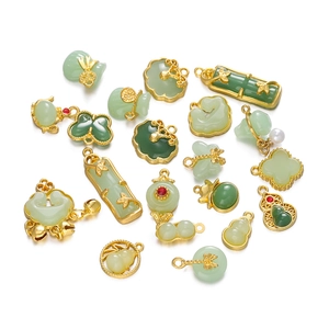 Detailed top view of assorted green jade-style pendants with gold-plated metal filigree