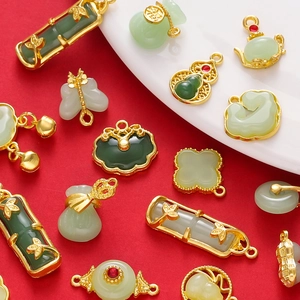 Macro view of Chinese style jade pendants with gold metal edges in various shapes