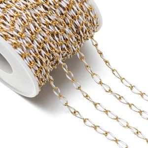 Macro view of gold plated chain with white enamel coating on a spool for DIY jewelry