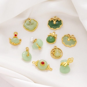 Close-up of assorted Chinese style jade and gold pendants with traditional cloud patterns