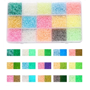 Detail of 15-grid box set showing glowing glass seed beads in various vibrant colors
