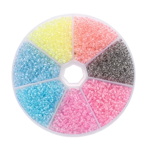 Top view of colorful 3mm luminous glass seed beads in a round 7-grid storage box for DIY