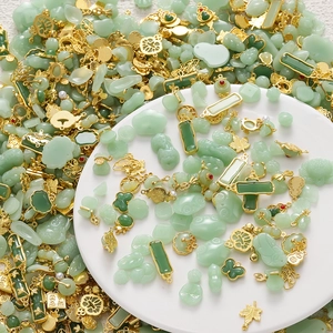 Macro detail of mixed green faux jade pendants with golden alloy Chinese knot ornaments