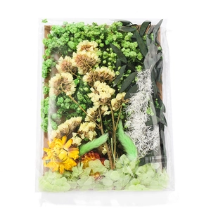 Detail of DIY dried flower material kit with yellow daisies and green starflower