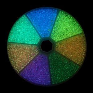 Luminous 3mm glass seed beads set in circular organizer with vibrant glowing colors