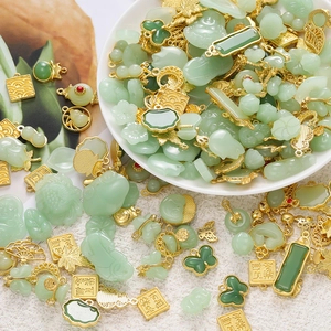 Macro shot of assorted Chinese style green faux jade pendants with golden metal bases