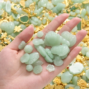 Macro detail of Chinese style jade pendants and golden alloy charms for DIY jewelry making