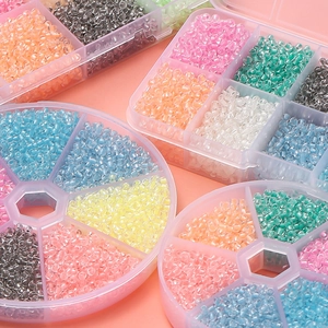 Detail of 3mm colorful glass seed beads set in a transparent multi-grid storage container