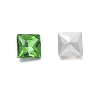 Macro view of grass green square crystal glass stone with silver pyramid pointed back