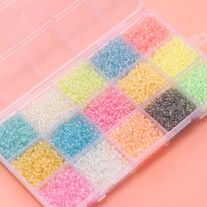 Macro view of 3mm colorful luminous glass seed beads set in 15-compartment storage box