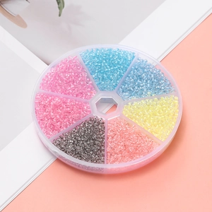 Macro detail of high-quality glass seed bead kit in a round transparent storage box