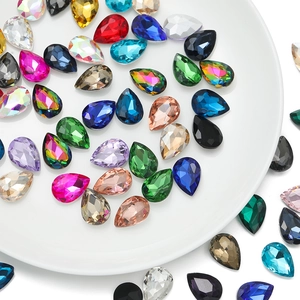Macro shot of colorful teardrop glass crystals with faceted cuts for DIY sewing projects