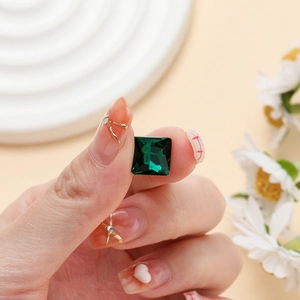 Macro shot of emerald green square glass crystal for DIY jewelry and nail art