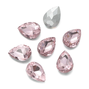 Macro detail of light pink teardrop glass rhinestones with silver backing for DIY sewing