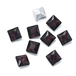 Macro view of multi-faceted square glass crystals in deep purple and silver colors
