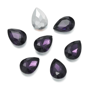 Macro detail of faceted purple teardrop crystal rhinestones with silver backing for DIY