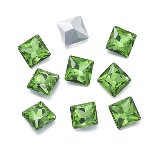 Macro detail of grass green square glass crystals with silver foiling for DIY crafts
