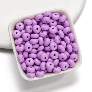 Close-up of 8mm lavender acrylic spacer beads in a white bowl for DIY jewelry making
