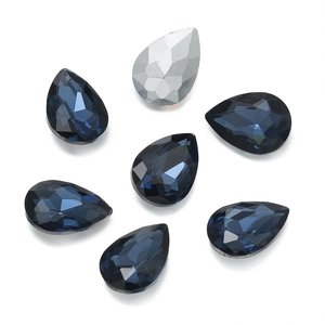 Macro shot of faceted teardrop glass rhinestones in deep blue and silver for DIY jewelry