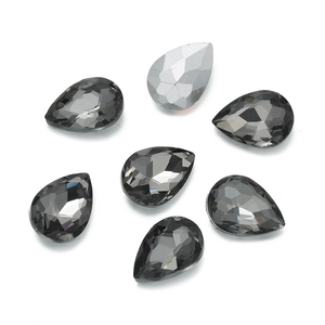 Detailed view of smoky grey teardrop crystal rhinestones with multifaceted glass cut